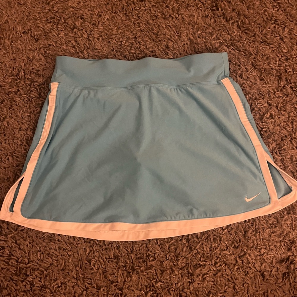 Light blue with white outline Nike tennis skirt with built in shorts.
